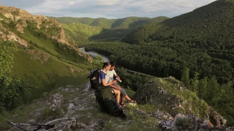 Backpacker couple has a rest in a rock mountains Stock Footage 70953244
