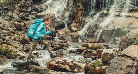 Backpacker crossing the river Stock Photos