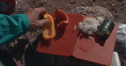 Backpacker Cutting Fresh Ingredients On Mini Board 스톡 동영상 105269491