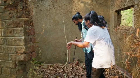 Backpacker enters abandoned structure into nature Stock Footage 303964827