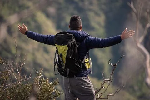 Backpacker explore a beautiful view at the top of the mountain after hiking Stock Photos