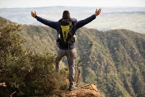 Backpacker explore a beautiful view at the top of the mountain after hiking Stock Photos