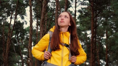 Backpacker feels cool breeze and explores nooks and crannies of evergreen forest Stock Footage 257566821