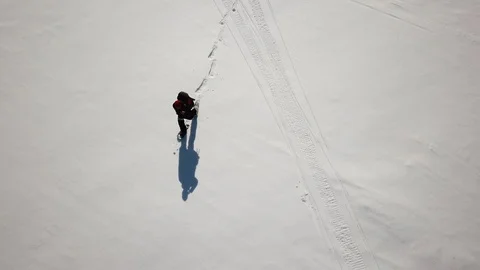 Backpacker on frozen lake Stock Footage 86617428