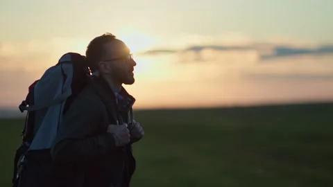 Backpacker guy enjoying hiking tourism walking on natural landscape at sunset Video stock 133343853