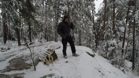 Backpacker having a cup of coffee and relaxing before next climb Stock Footage 145954145