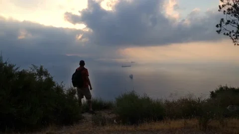 The backpacker hiker stops because of the atmospheric view. Stock Footage 138208059
