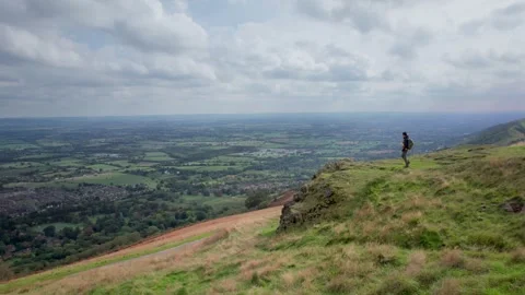 Backpacker hiker walking on the peak of Malvern Hills Stock Footage 287214549