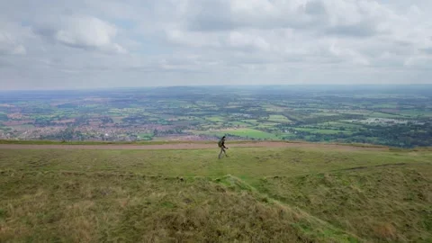 Backpacker hiker walking on the peak of Malvern Hills Stock Footage 287214583