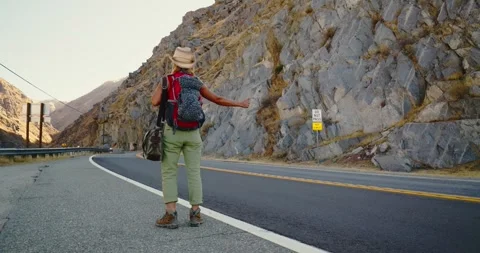 Backpacker Hiking Along Mountain Road in Scenic Valley Stock Footage 323343374