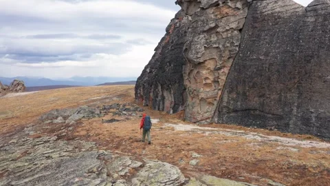 Backpacker hiking in mountain pass Stock Footage 313492625