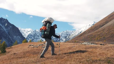 Backpacker hiking through majestic mountain terrain Stock Footage 291336734