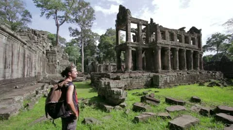 Backpacker looking preah khan temple, angkor, cambodia Stock Footage 12172147