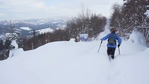 Backpacker man going through deep snow at sunset. Stock Footage 101511190