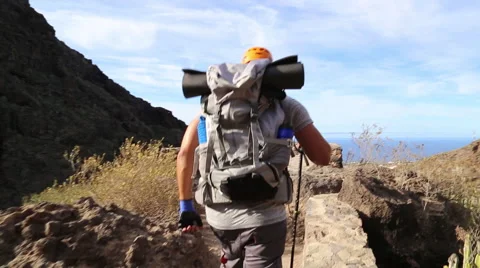 Backpacker man hiking and rising hands up in beautiful landscapes of Barranco 스톡 동영상 68855874