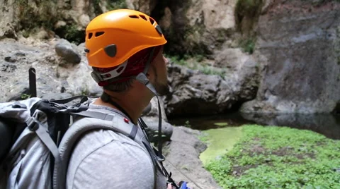 Backpacker man hiking and taking pictures of waterfall in Barranco del Infier Stock Footage 68856521