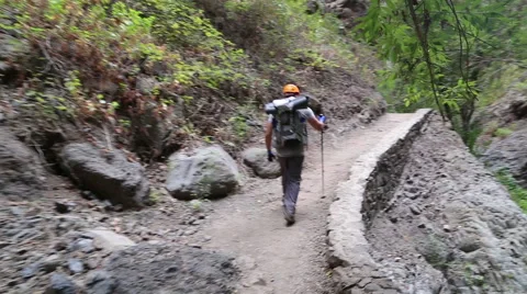 Backpacker man hiking in beautiful landscapes of Barranco del Infierno in Ten Stock Footage 68856469