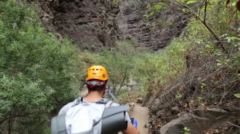 Backpacker man hiking in beautiful landscapes of Barranco del Infierno in Ten Stock Footage 68856492