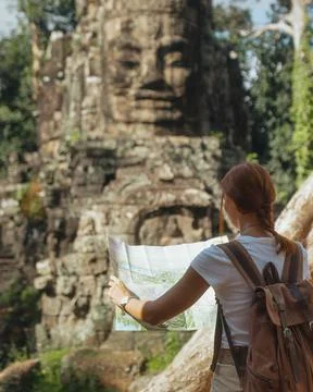 Backpacker With Map Exploring Bayon Face Tower, Angkor Thom, Cambodia Stock Photos