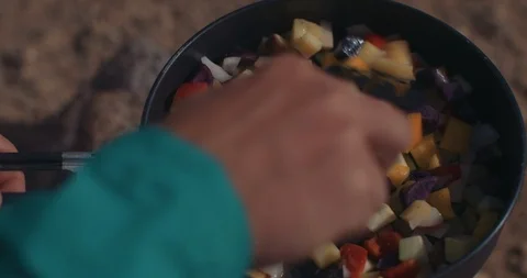 Backpacker Mixing Ingredients In Pot 스톡 동영상 105268930