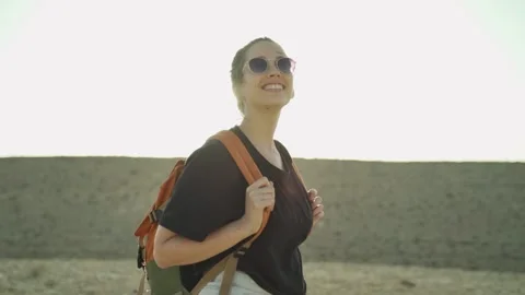 Backpacker or hiker with backpack enjoys the desert mountains and plains Stock Footage 220629631