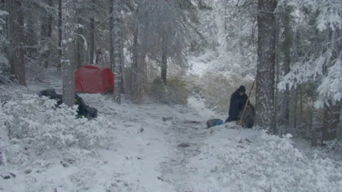 Backpacker on the Pacific Crest Trail waking up to year’s first snowfall Stock Footage 169320427