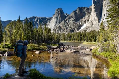 Backpacker pauses at lake - Wind River Range, Wyoming Stock Photos