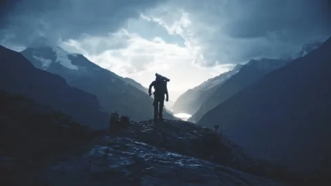 Backpacker on peak of mountain Stock Footage 136123521