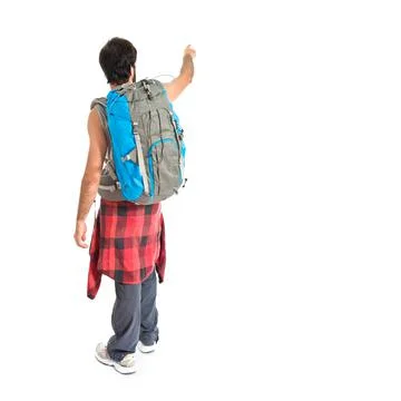Backpacker pointing back over white background Stock Photos