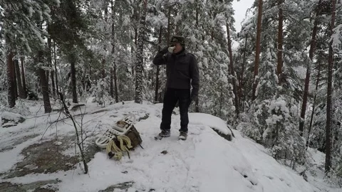 Backpacker resting on a cliff and having a cup of coffee Stock Footage 145954254