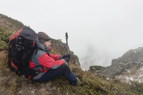 Backpacker resting on a mountain trail Stockfoto's