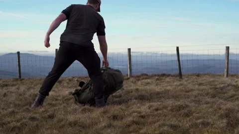 A backpacker rummaging through a backpack outdoors 動画素材 234919635