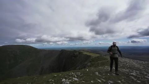 A backpacker running along a mountain ridge Stock Footage 139460923