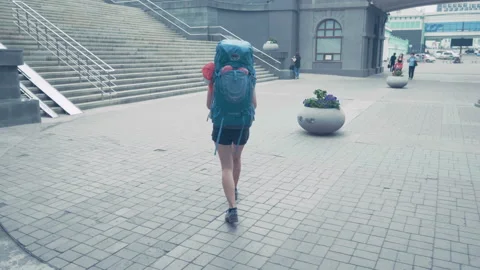 Backpacker running up church stairs while sight seeing Stock Footage 93017351