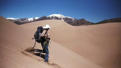 Backpacker Running Down Steep Sand in Slow Motion in Sand Dunes National Park Video stock 106071786