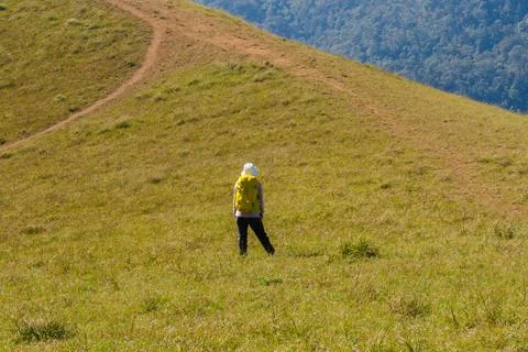 Backpacker standing on the mountain Stock Photos