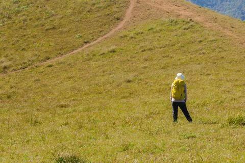 Backpacker standing on the mountain Stock Photos