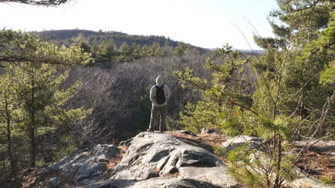 Backpacker Standing on Peak Viewing Horizon Video stock 237209111