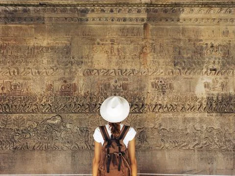 Backpacker Studying Angkor Wat Bas-Reliefs, Cultural Tourism Concept Stock Photos