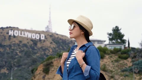 Backpacker with sunglasses looking around Video stock 97857509