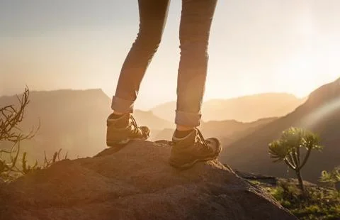 Backpacker on top of the mountain at the sunset Stock Photos