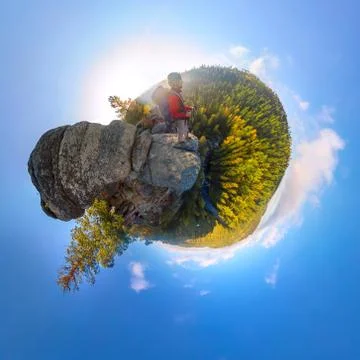 Backpacker on top of a rock fall at dawn. spherical degree panorama 360 180 l Stock Photos