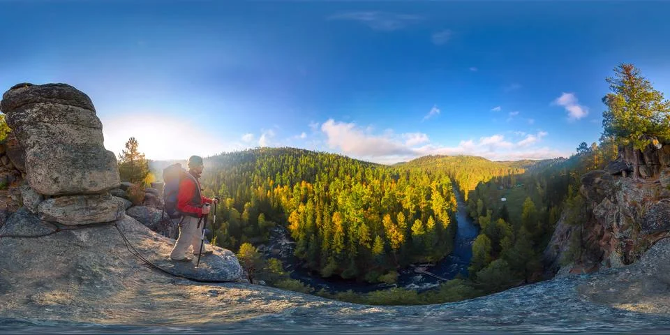 Backpacker on top of a rock fall at dawn. Spherical panorama 360 180 degrees  Stock Photos