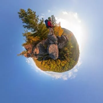 Backpacker on top of a rock fall at dawn. spherical degree panorama 360 180 l Stock Photos