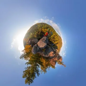 Backpacker on top of a rock fall at dawn. spherical degree panorama 360 180 l Stock Photos