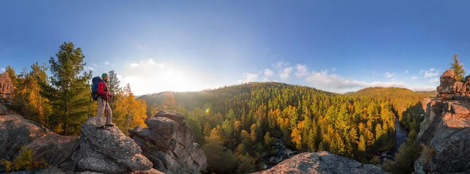 Backpacker on top of a rock fall at dawn. Cylindrical panorama 360 degrees Stock Photos
