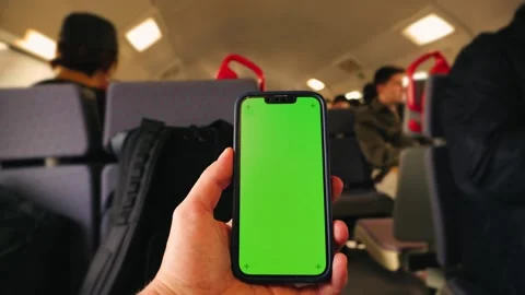 Backpacker traveling on a high-speed train using a smartphone with a green Stock Footage 334537588