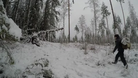 Backpacker walking along snowy path from right to distance and back Stock Footage 145944683