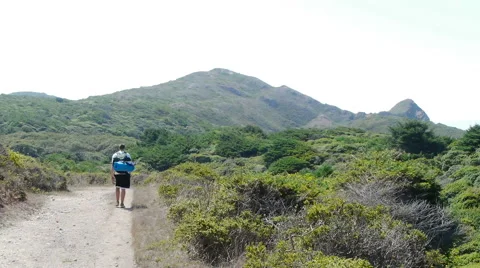 Backpacker Walking Along Trail with Hills Stock-Footage 41606833