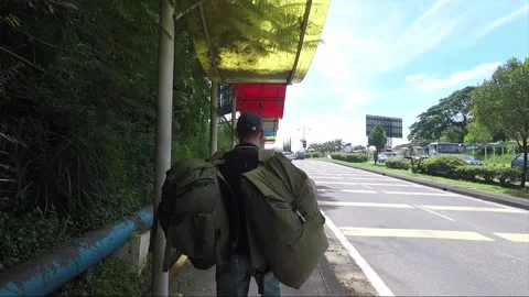 The backpacker walking away along the road in Borneo, Malaysia Stock Footage 143583640
